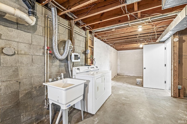 basement featuring sink and separate washer and dryer