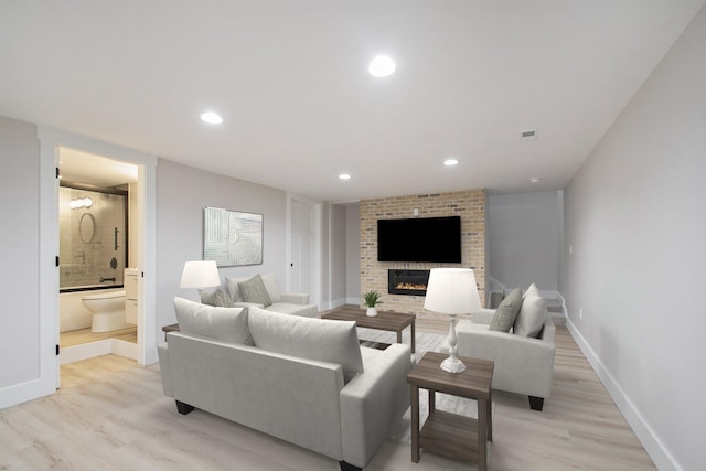 living room featuring a fireplace and light hardwood / wood-style flooring