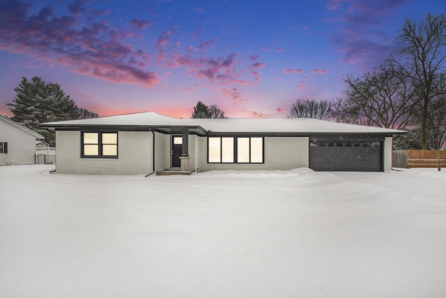 view of snow covered rear of property