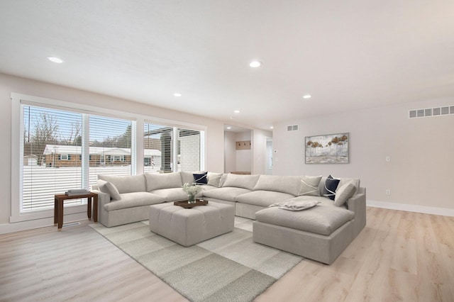 living room with light hardwood / wood-style flooring