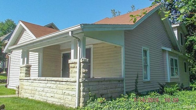 view of side of property with covered porch