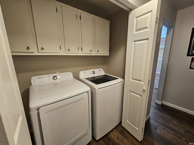 laundry room featuring dark hardwood / wood-style flooring, separate washer and dryer, and cabinets