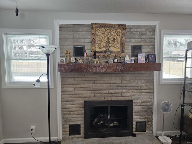 interior details featuring a brick fireplace