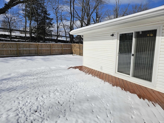 yard covered in snow with a wooden deck