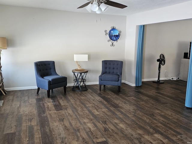 sitting room featuring ceiling fan and dark wood-type flooring