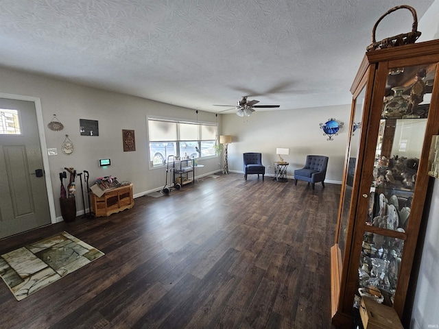 foyer featuring ceiling fan, dark hardwood / wood-style floors, and a textured ceiling