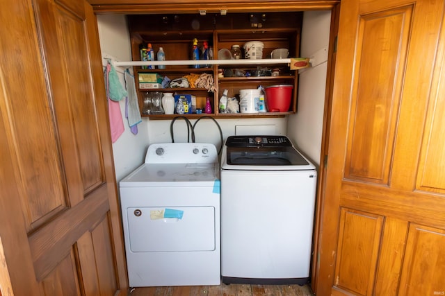 clothes washing area with washing machine and dryer