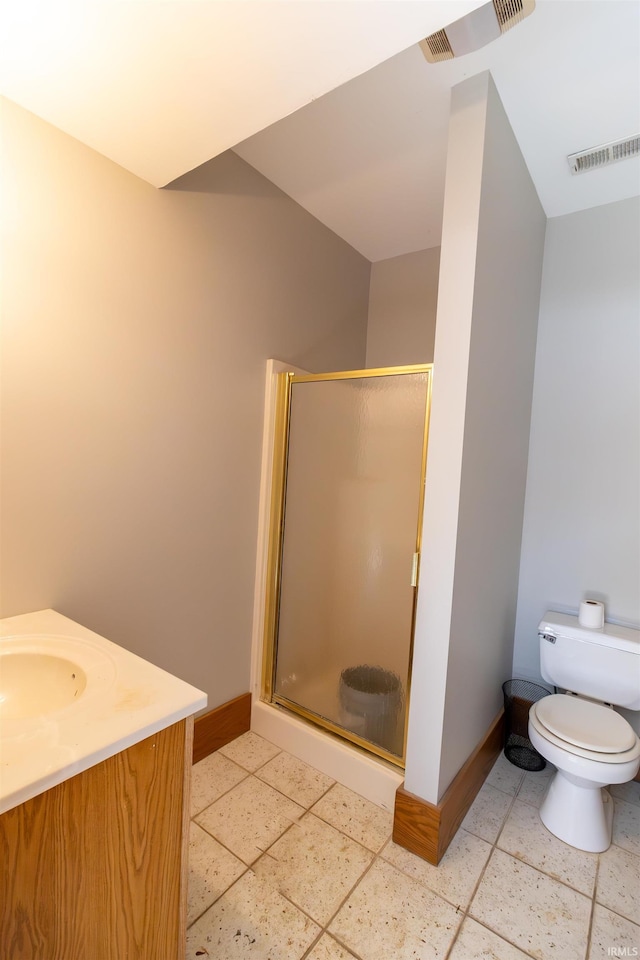 bathroom featuring an enclosed shower, vanity, and toilet