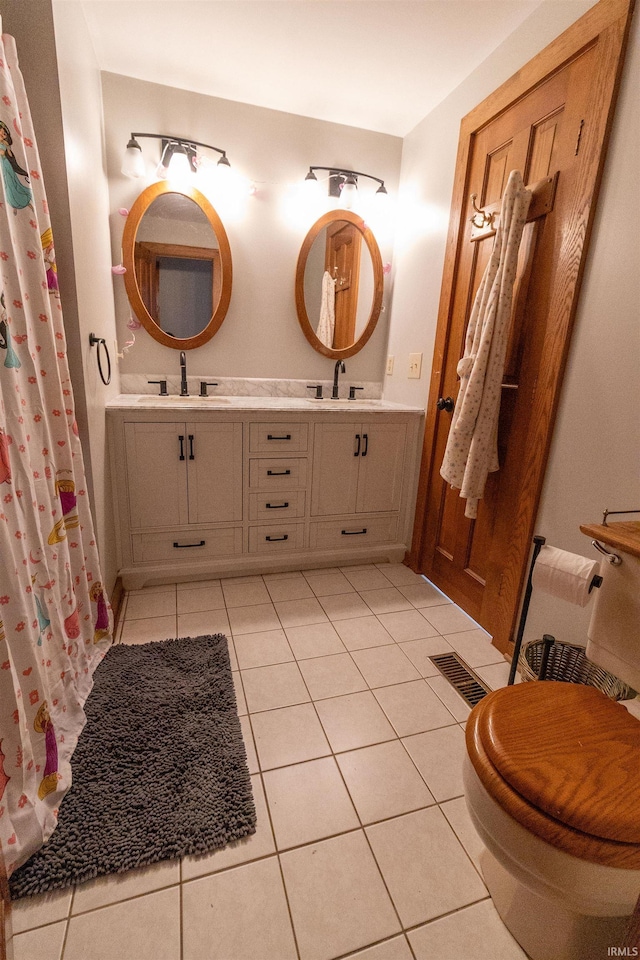 bathroom featuring vanity, toilet, and tile patterned floors