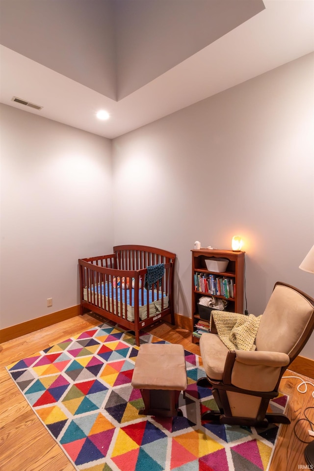 bedroom with hardwood / wood-style flooring