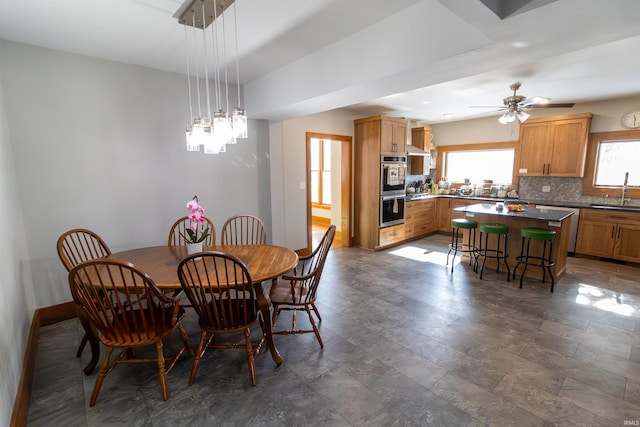 dining area featuring sink and ceiling fan