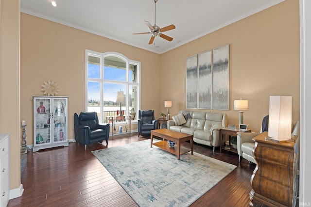 living room featuring ceiling fan, dark hardwood / wood-style flooring, and ornamental molding