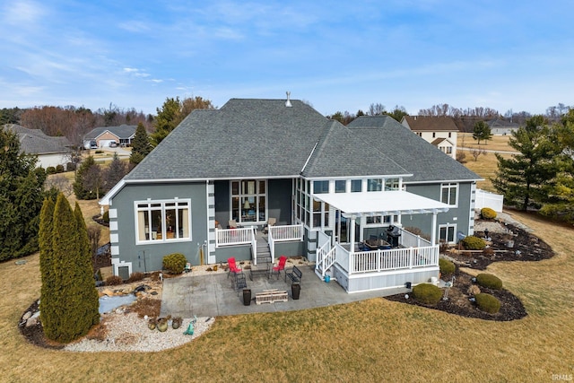 rear view of house with a lawn, a pergola, and a patio area