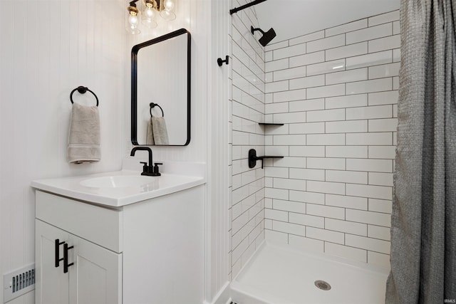 bathroom featuring vanity, a shower stall, and visible vents