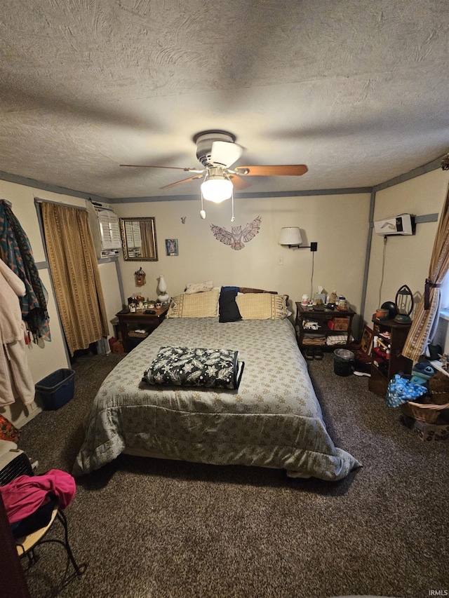 bedroom with ceiling fan, carpet flooring, and a textured ceiling