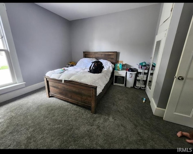 bedroom featuring dark carpet