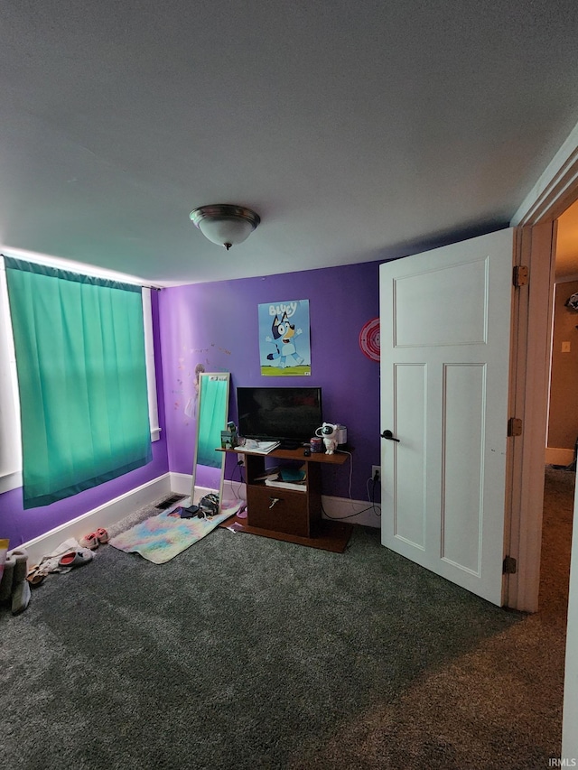 recreation room featuring dark carpet