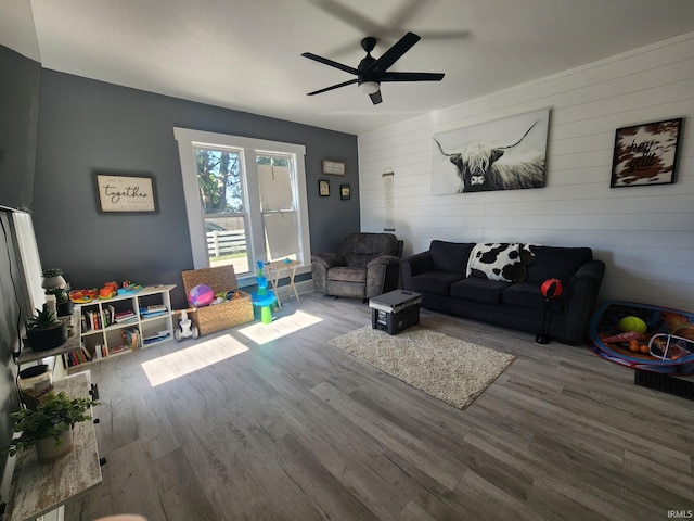 living room with hardwood / wood-style floors and ceiling fan