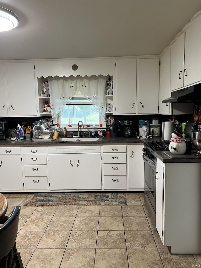 kitchen with light tile patterned floors, sink, white cabinetry, and stainless steel range with gas stovetop