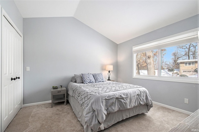 carpeted bedroom with lofted ceiling