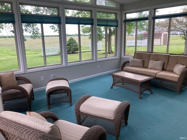 sunroom featuring a water view and a wealth of natural light