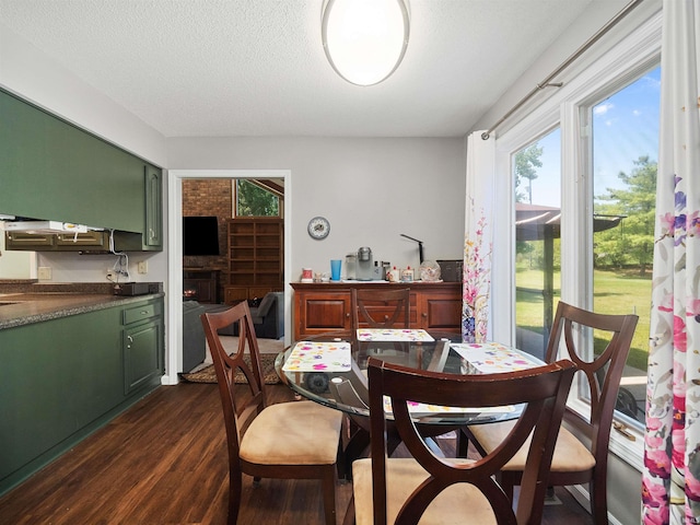 dining area featuring a textured ceiling and dark wood-type flooring