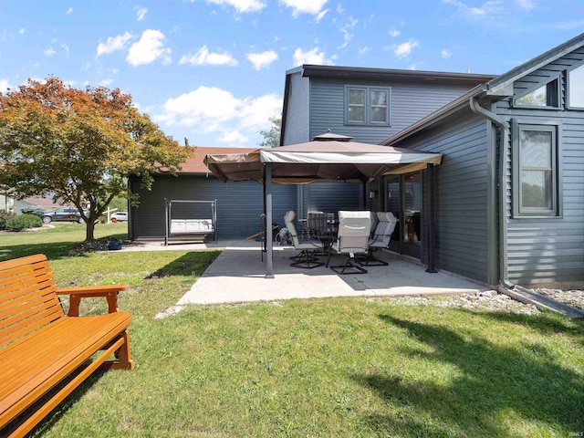 rear view of house with a patio area and a lawn