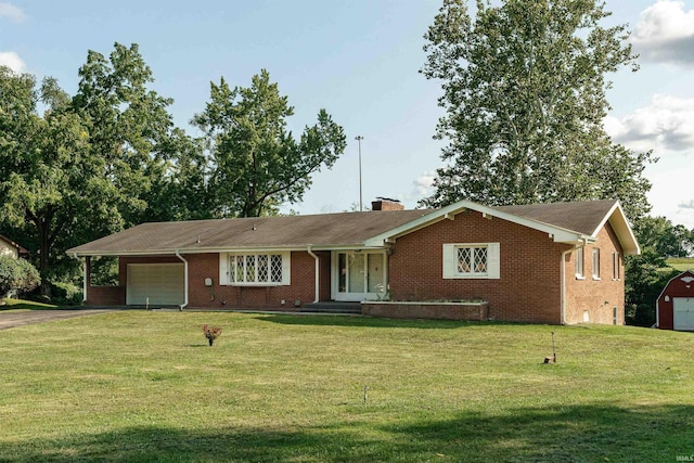 single story home featuring a garage and a front yard