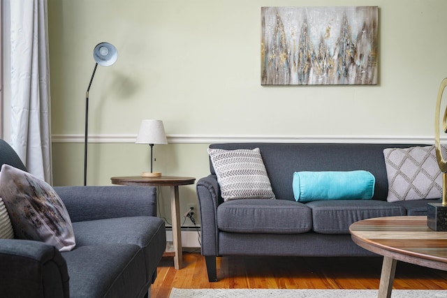 living area with light hardwood / wood-style floors and a baseboard radiator