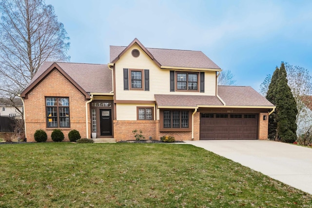 traditional-style home with a front yard, an attached garage, driveway, and brick siding