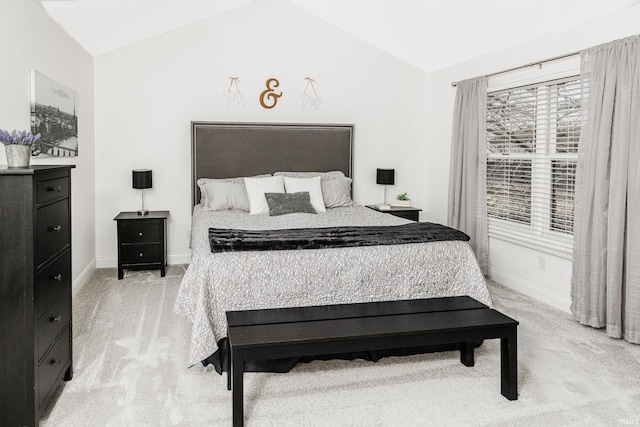 bedroom featuring light carpet, vaulted ceiling, and baseboards