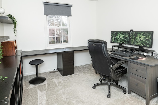 office featuring light carpet and baseboards