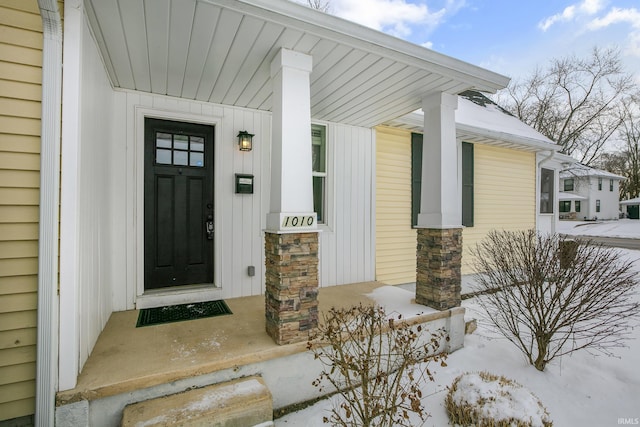 view of snow covered property entrance