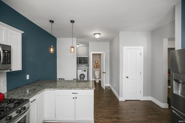 kitchen with white cabinets, stone countertops, and appliances with stainless steel finishes