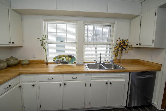 kitchen with white cabinetry, a sink, and stainless steel dishwasher