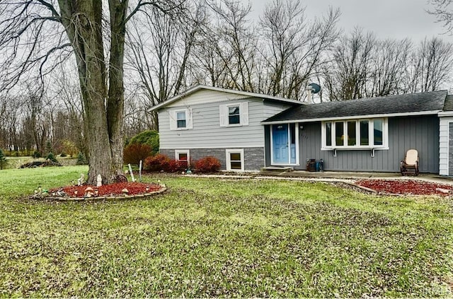 tri-level home with a front yard