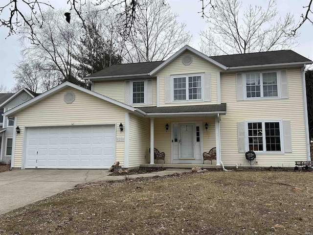 traditional home with concrete driveway and an attached garage