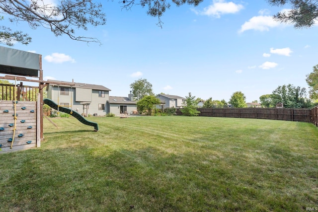 view of yard featuring a playground and fence