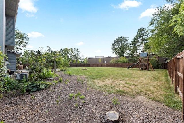 view of yard featuring a fenced backyard and a playground