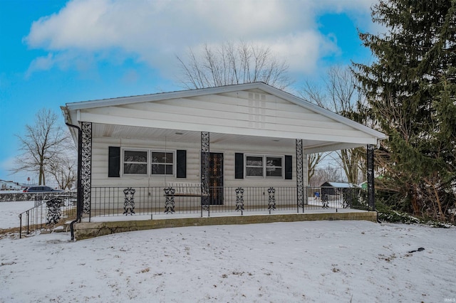 view of front of home featuring a fenced front yard and a carport