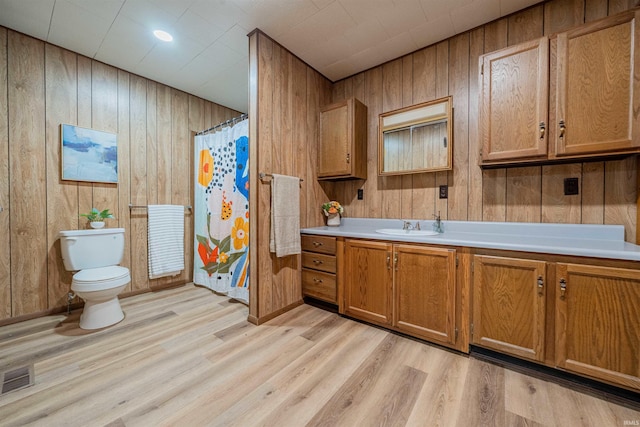 bathroom featuring visible vents, vanity, toilet, and wood finished floors