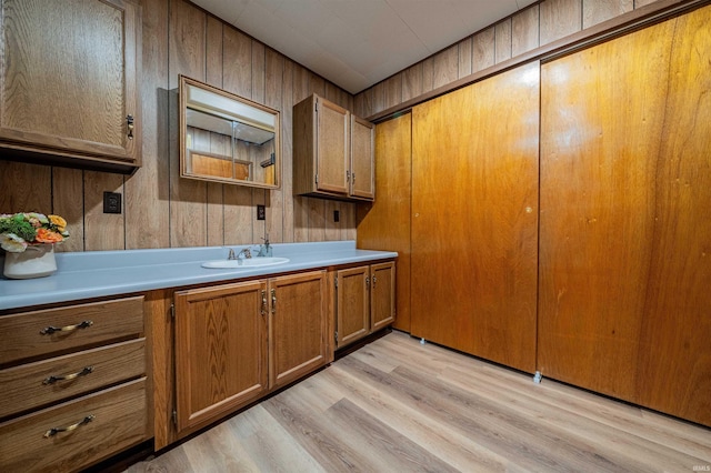 kitchen with a sink, light countertops, and brown cabinets