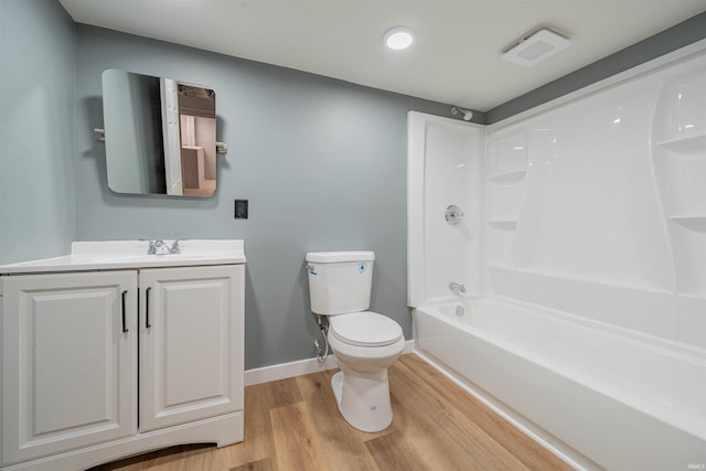 full bath featuring baseboards, shower / bath combination, toilet, vanity, and wood finished floors