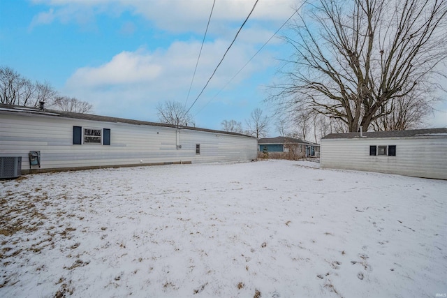 snow covered property featuring central air condition unit