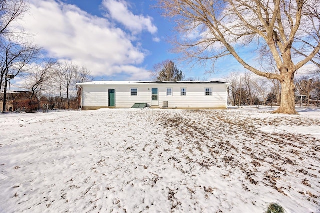 view of snow covered back of property