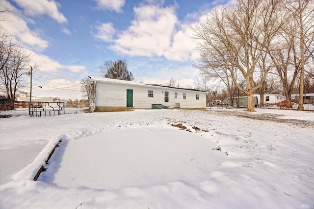 view of snow covered back of property