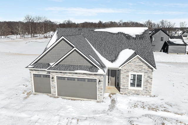 view of front of property with a garage, stone siding, and roof with shingles