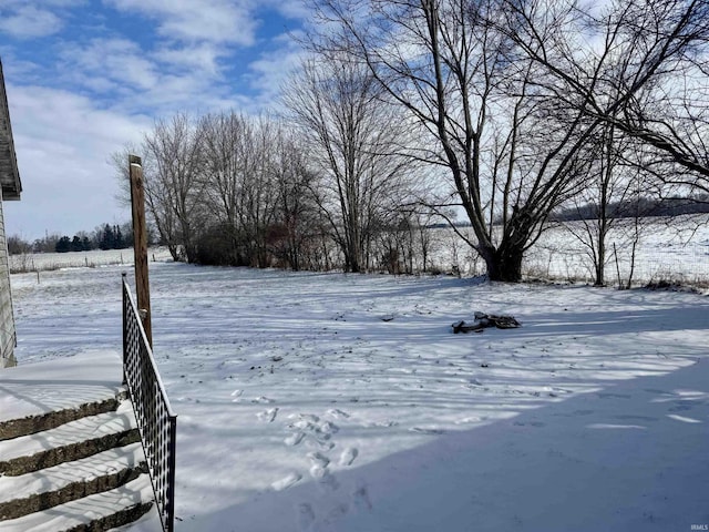 snowy yard with fence