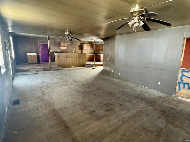 unfurnished living room featuring visible vents and a ceiling fan