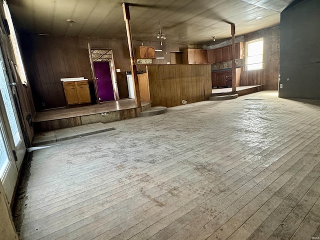 interior space with light wood finished floors and wooden walls